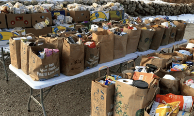 bags of donated food on tables outside